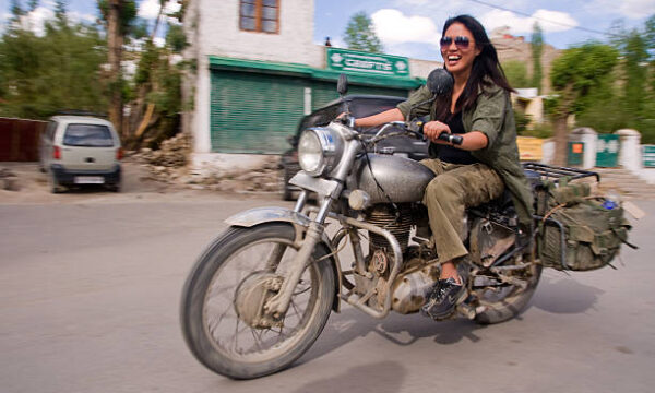 [UNVERIFIED CONTENT] Female tourist riding a motorcycle in Leh (Ladakh).

Leh was the capital of the Himalayan kingdom of Ladakh, now the Leh District in the Indian State of Jammu and Kashmir. Leh District is the second largest district (in terms of area).

Ladakh is a remote and sparsely populated region in the north-eastern most part of the Indian state of Jammu and Kashmir, that is subject to ongoing territorial disputes between India and Pakistan and with distinct cultural influences and historical ties to Tibet.

Ladakh is a popular travel destination to adventurous tourists and motorcyclists. The favorite motorcycle for travelling in the Himalaya mountains is the Indian-made Royal Enfield "Bullet".

Other keywords: people, woman, motorbike, speed, fast, road, street, driving, transportation, excitement, Human interest, Lifestyle.
